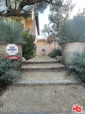 a spacious bedroom with a bed and dresser with wooden floor