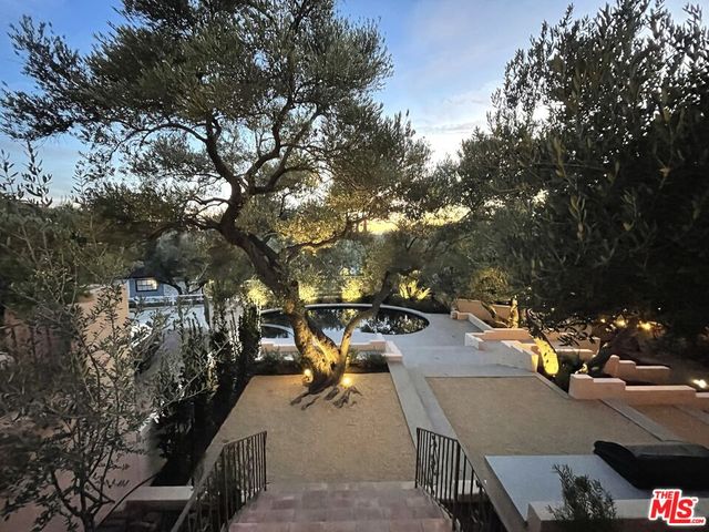 a view of a terrace with a bench and trees