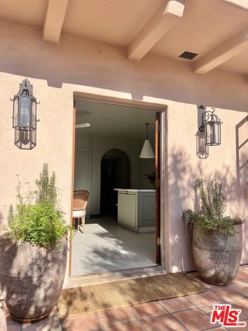 a living room with furniture a bookshelf and a window