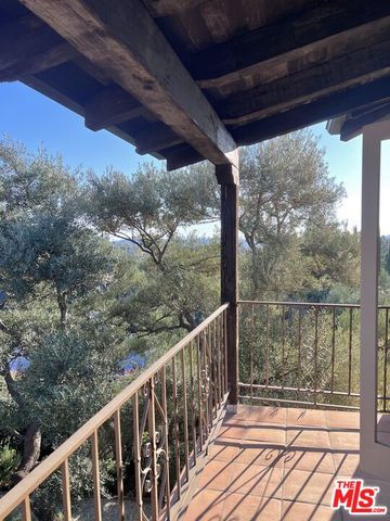 a living room with furniture and floor to ceiling window