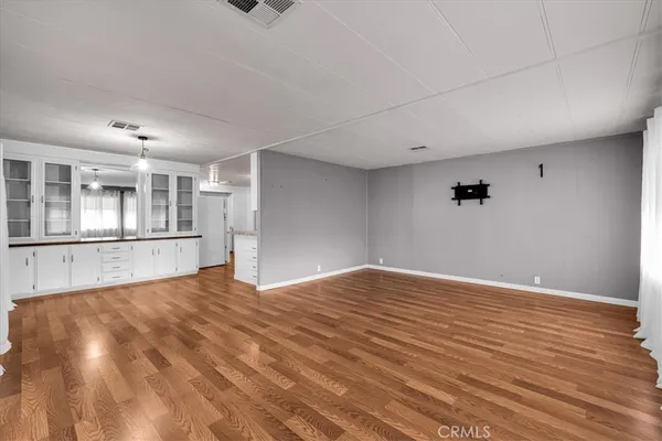 a large white kitchen with granite countertop a large window