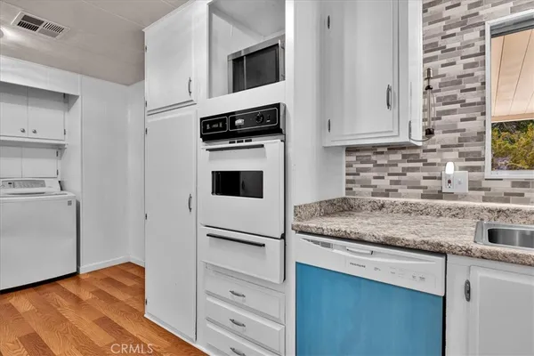 a kitchen with stainless steel appliances a refrigerator and a stove top oven