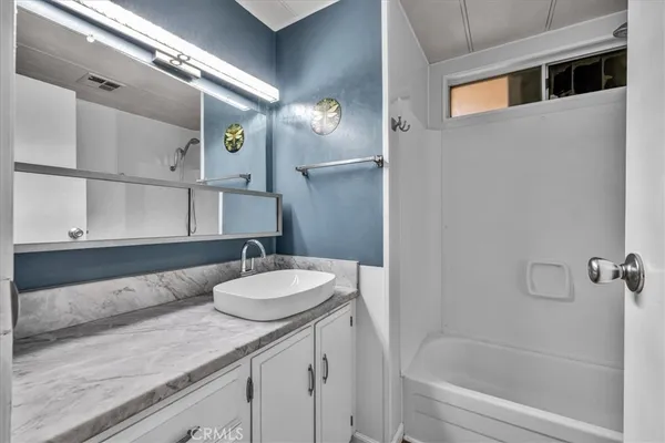 a bathroom with a bathtub and a toilet