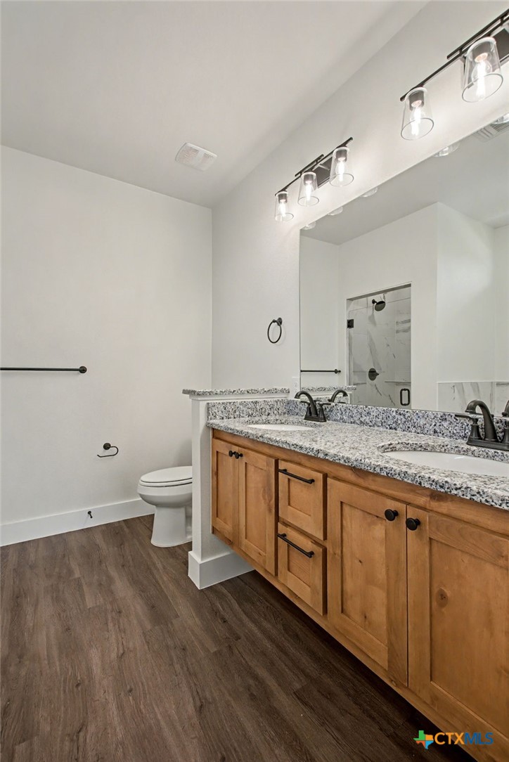 425 County Road 3152 Kempner, TX 76539 - Photo 15 of 27 a bathroom with a granite countertop double vanity sink and mirror