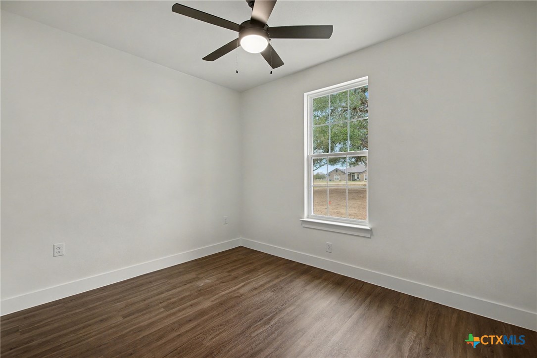 425 County Road 3152 Kempner, TX 76539 - Photo 22 of 27 a view of an empty room with wooden floor and a window