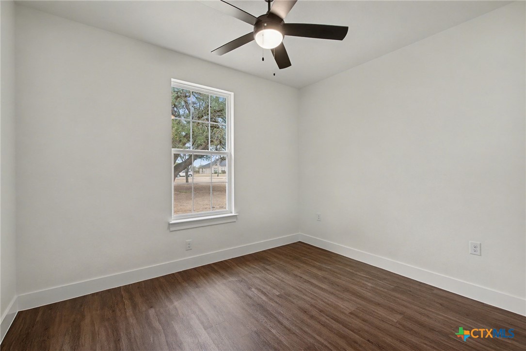 425 County Road 3152 Kempner, TX 76539 - Photo 23 of 27 wooden floor in an empty room with a window