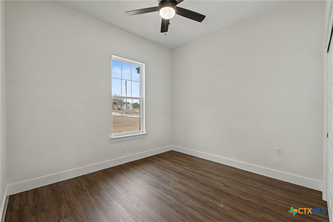 425 County Road 3152 Kempner, TX 76539 - Photo 24 of 27 a view of an empty room with wooden floor and a window