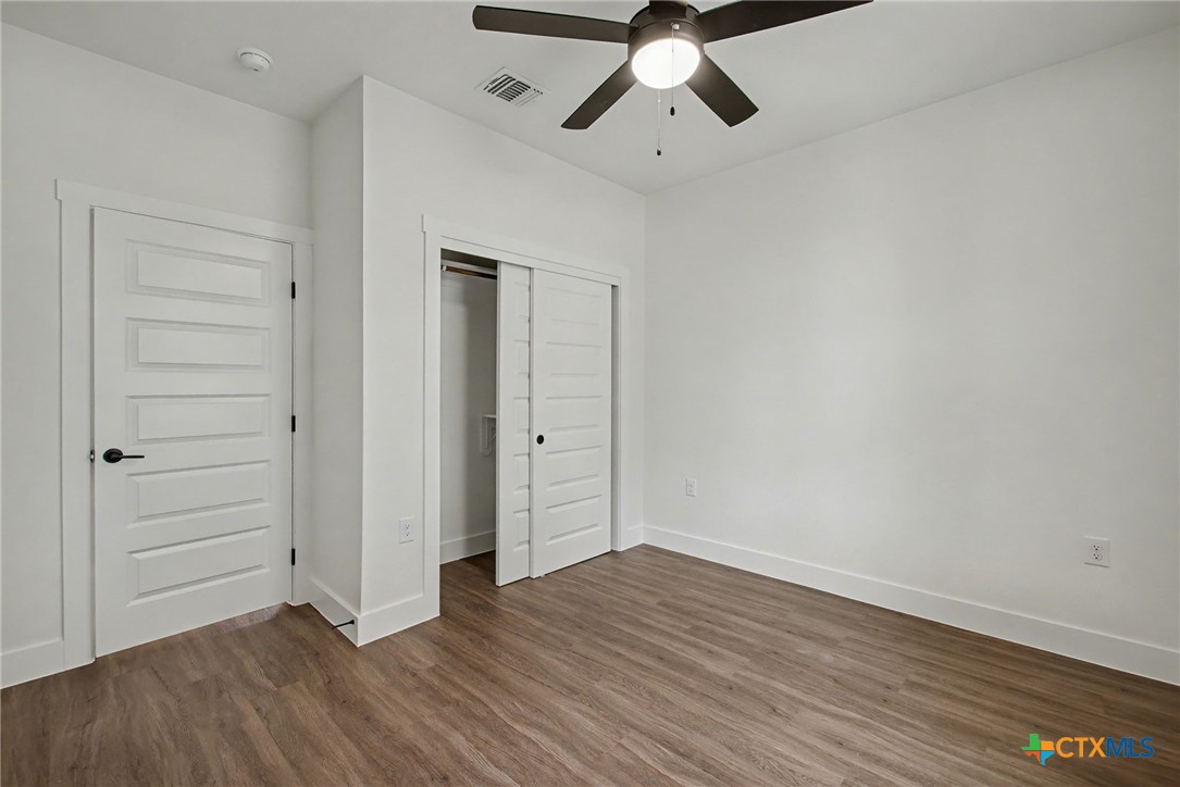 425 County Road 3152 Kempner, TX 76539 - Photo 26 of 27 an empty room with wooden floor closet and windows