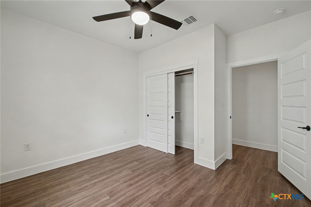 425 County Road 3152 Kempner, TX 76539 - Photo 27 of 27 an empty room with wooden floor and ceiling fan