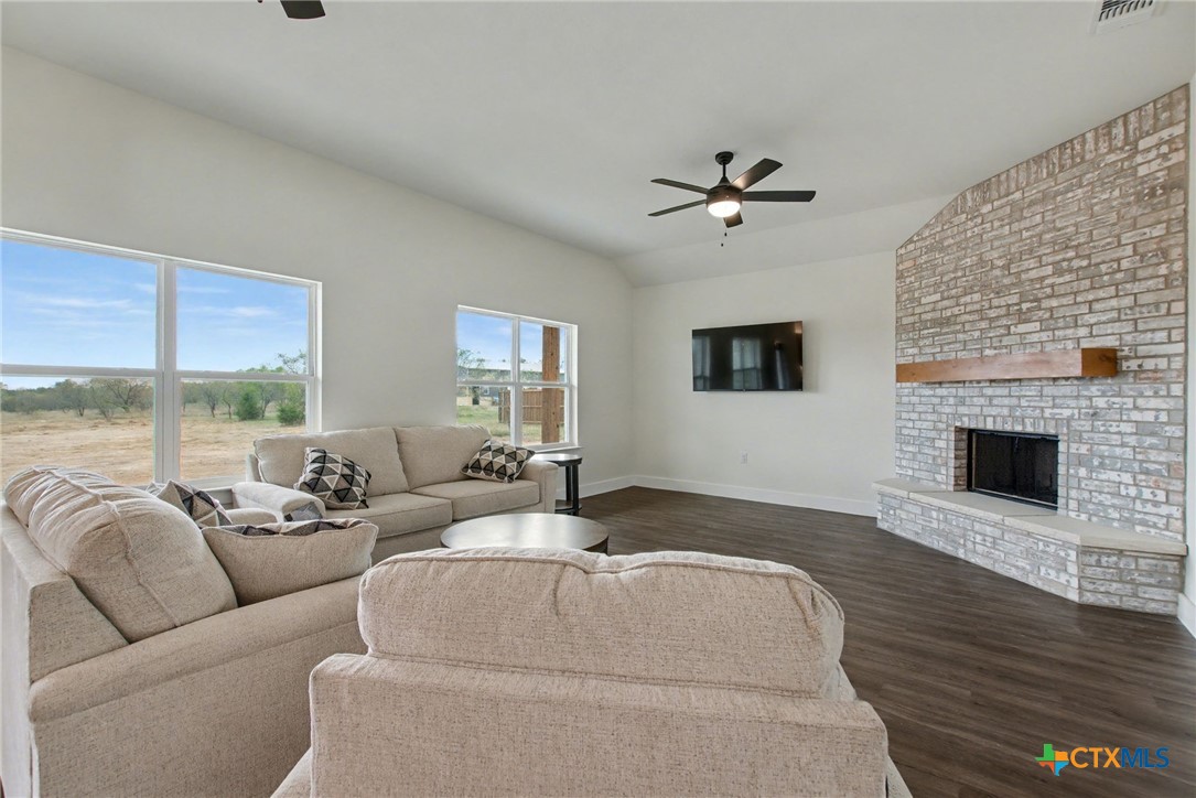 425 County Road 3152 Kempner, TX 76539 - Photo 6 of 27 a living room with furniture a fireplace and a flat screen tv