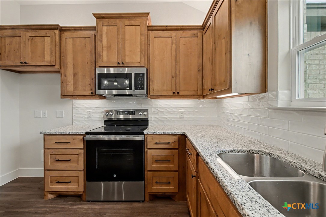 425 County Road 3152 Kempner, TX 76539 - Photo 10 of 27 a kitchen with stainless steel appliances granite countertop a stove and a sink