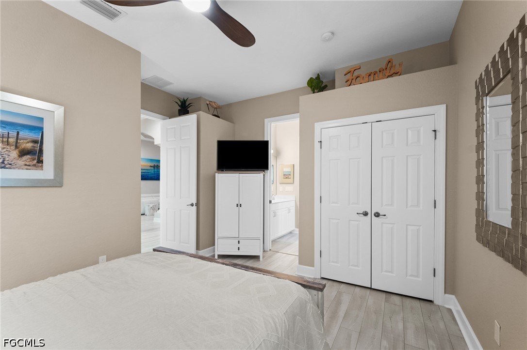 9042 Bronco Court Naples, FL 34113 - Photo 22 of 50 a spacious bedroom with a bed and a television