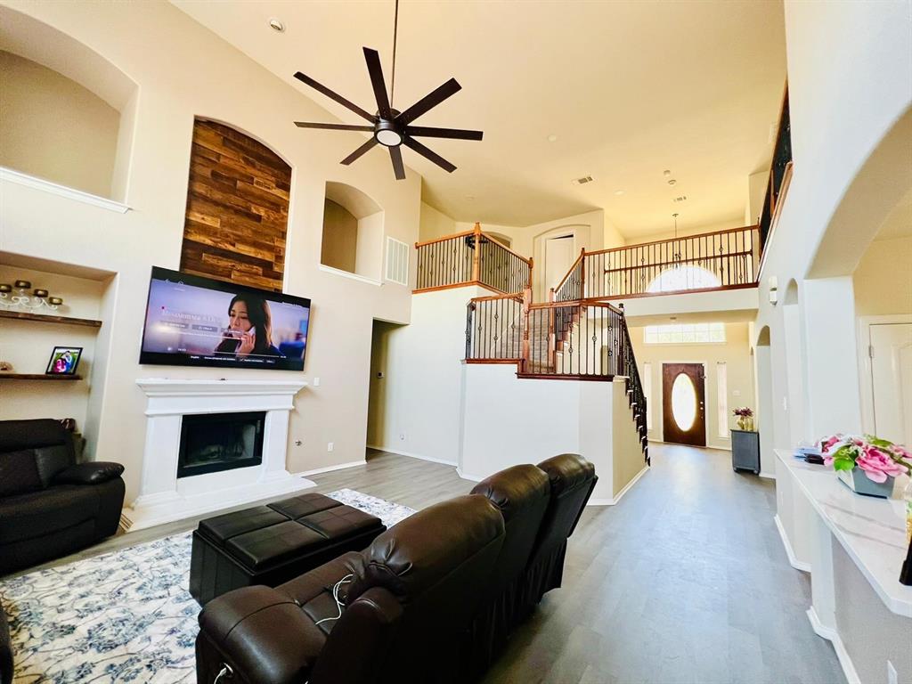 3604 Rams Horn Way Round Rock, TX 78665 - Photo 8 of 26 A spacious living area with soaring ceilings and a grand double staircase, perfect for welcoming guests.
