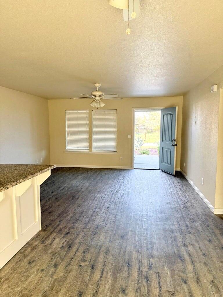 1310 North Belmont Road Exeter, CA 93221 - Photo 7 of 15 an empty room with wooden floor and windows