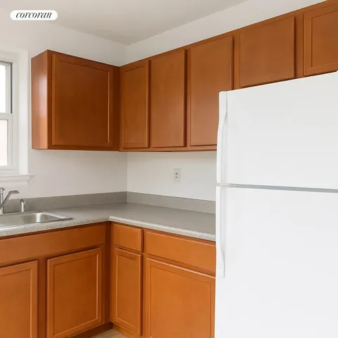 a kitchen with a refrigerator and cabinets