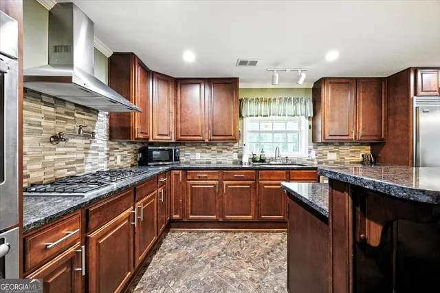 a kitchen with a sink stove and refrigerator