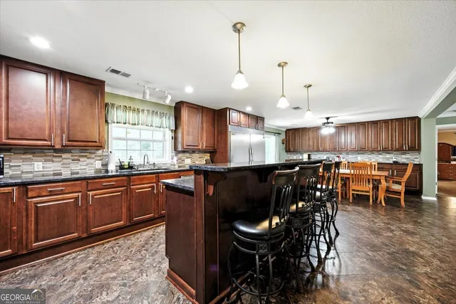 a bedroom with a bed and a flat tv screen on dresser