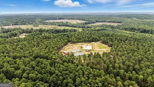a dining room with furniture a rug and a kitchen