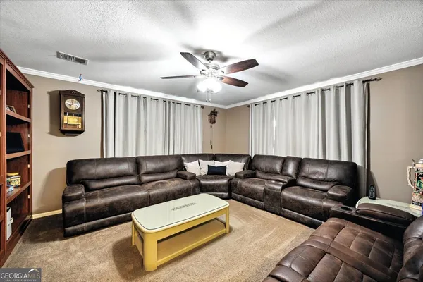 a view of a backyard with a garden and entertaining space