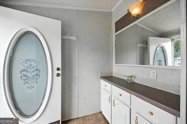 a bathroom with a granite countertop sink a toilet and a mirror
