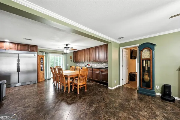 a view of a big room with wooden floor windows and cabinet