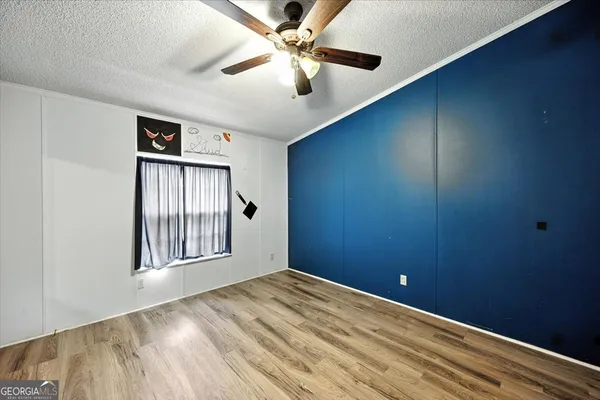 an aerial view of residential houses with outdoor space and trees