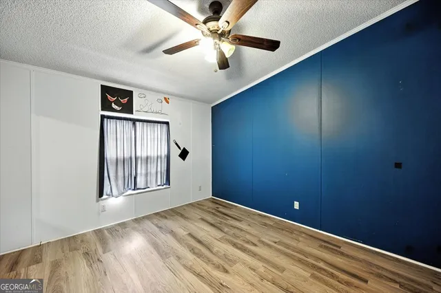 an aerial view of residential houses with outdoor space and trees