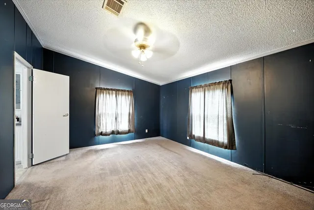 an aerial view of residential houses with outdoor space and trees