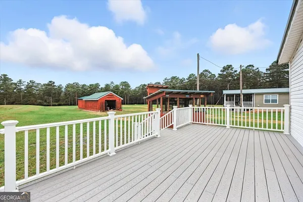 an aerial view of residential houses with outdoor space and trees
