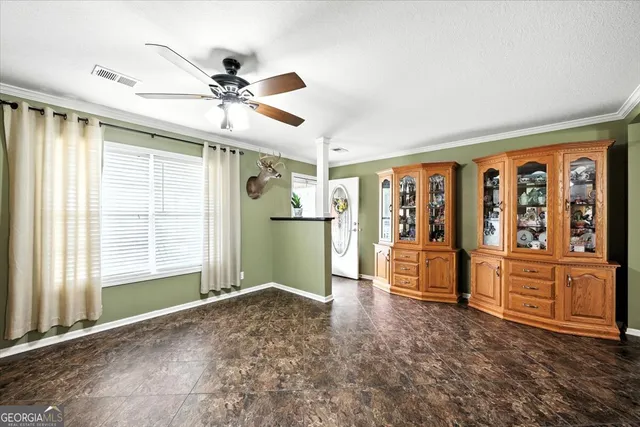 a spacious bedroom with a bed and a flat screen tv