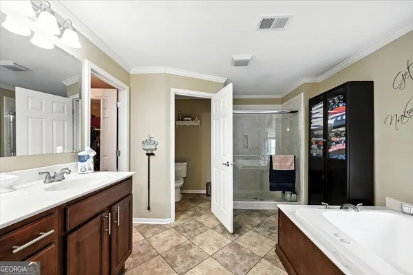 a kitchen with stainless steel appliances a dining table chairs sink and cabinets