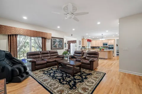 a living room with lots of furniture wooden floor and a rug