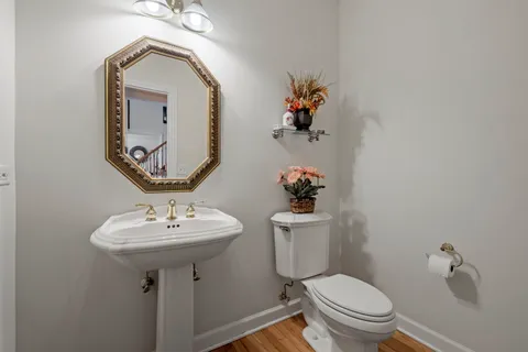 a bathroom with a toilet sink and mirror