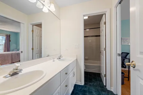 a bathroom with a double vanity sink and a mirror