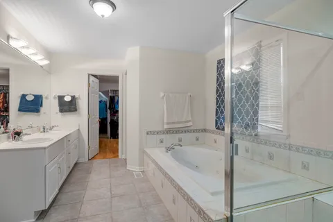 a spacious bathroom with a bathtub and a sink