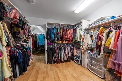 a view of walk in closet with clothes