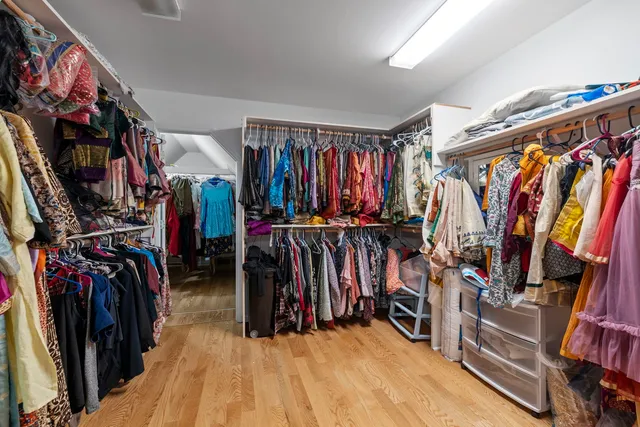 a view of walk in closet with clothes