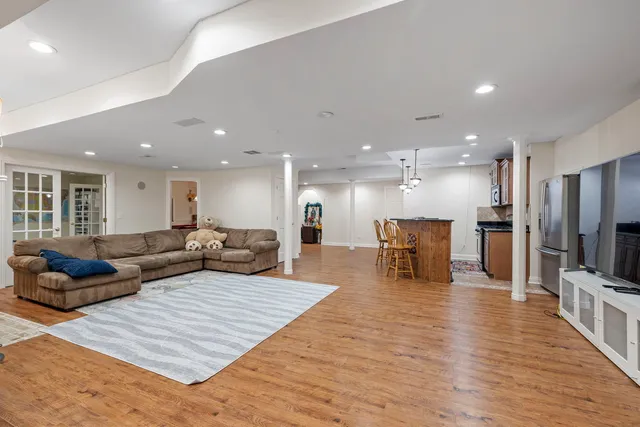 a living room with furniture and a wooden floor