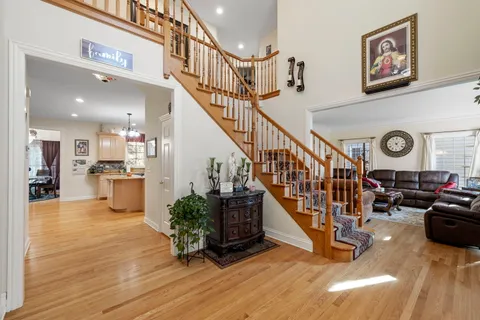 a view of entryway and hall with wooden floor