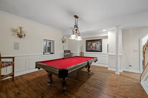 a living room with a table tennis pool table and chair