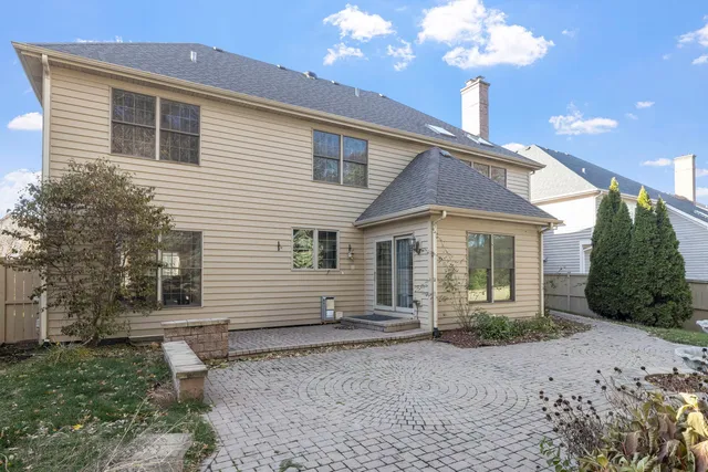a front view of a house with a yard and potted plants