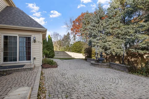 a view of a house with a yard and pathway