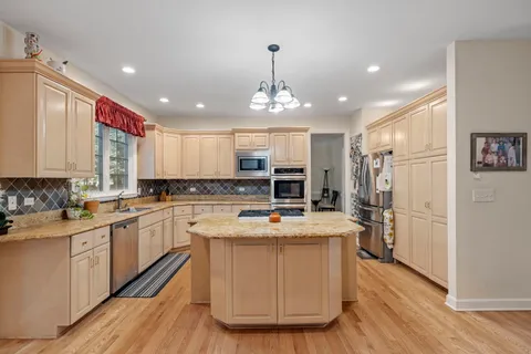 a kitchen with a stove a refrigerator and a sink