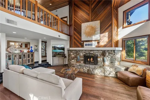 a living room with furniture fireplace and a large window