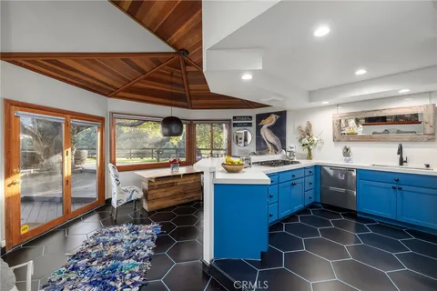a kitchen with a sink and a stove top oven
