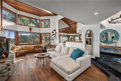 a dining room with furniture and wooden floor