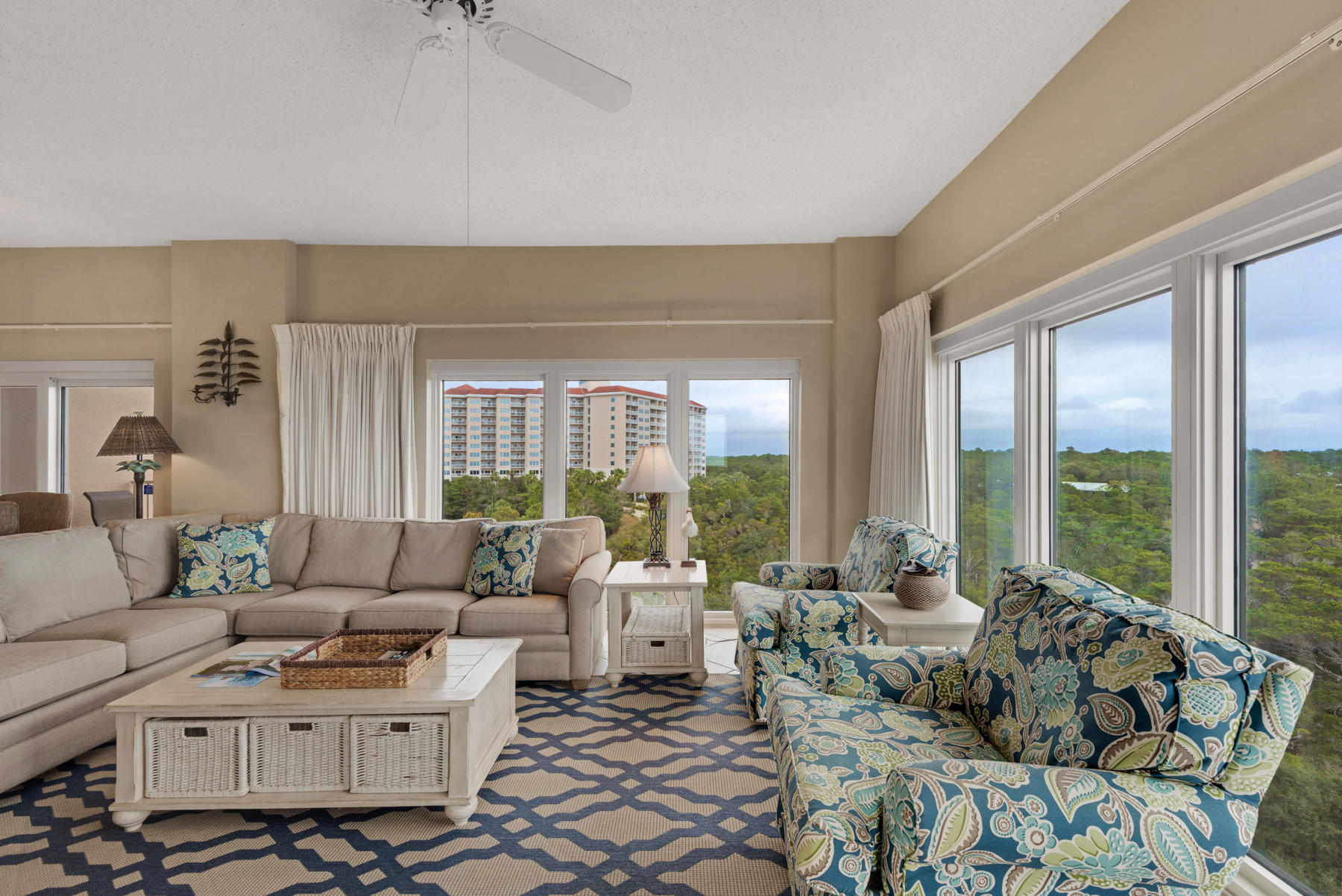 a living room with furniture and large windows