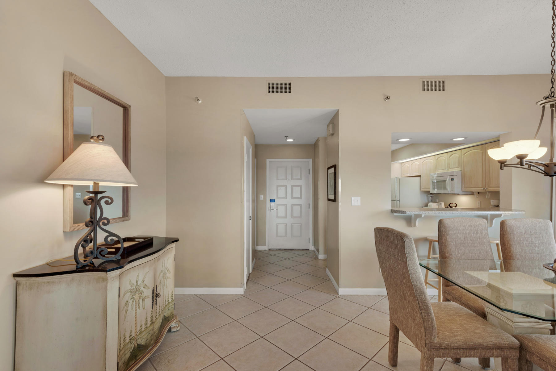 9011 Highway 98, Unit 701 Miramar Beach, FL 32550 - Photo 2 of 13 a kitchen that has a table and chairs in it