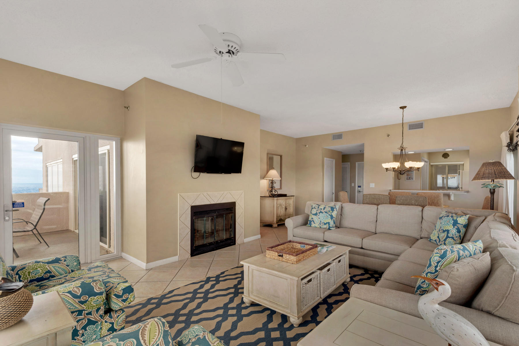 9011 Highway 98, Unit 701 Miramar Beach, FL 32550 - Photo 4 of 13 a living room with furniture a fireplace and a flat screen tv