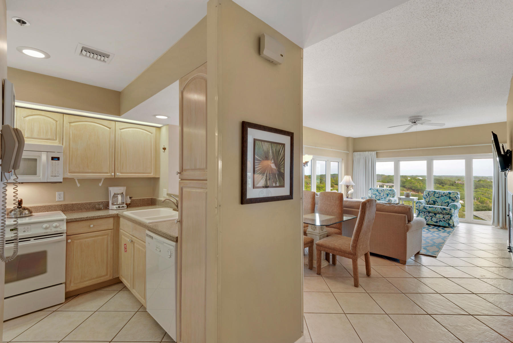 9011 Highway 98, Unit 701 Miramar Beach, FL 32550 - Photo 6 of 13 a living room with furniture a dining table and chairs with kitchen view